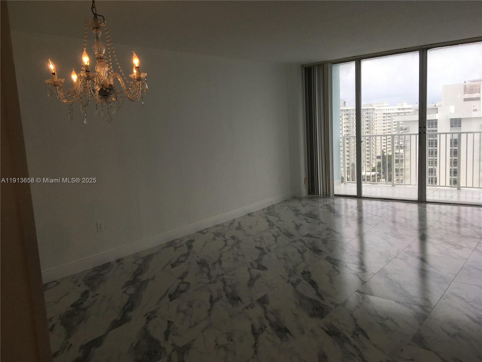 5838 Collins Avenue, Unit PHF Miami Beach, FL 33140 - Photo 4 of 16 a view of an empty room with a window