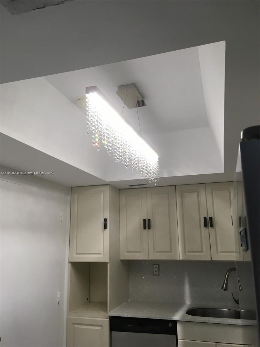 5838 Collins Avenue, Unit PHF Miami Beach, FL 33140 - Photo 6 of 16 a kitchen with white cabinets and a window