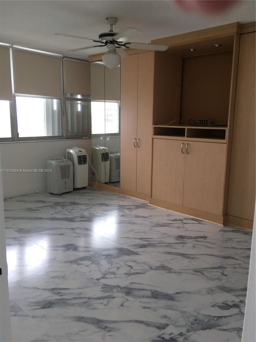 5838 Collins Avenue, Unit PHF Miami Beach, FL 33140 - Photo 7 of 16 a room with wooden floor and windows