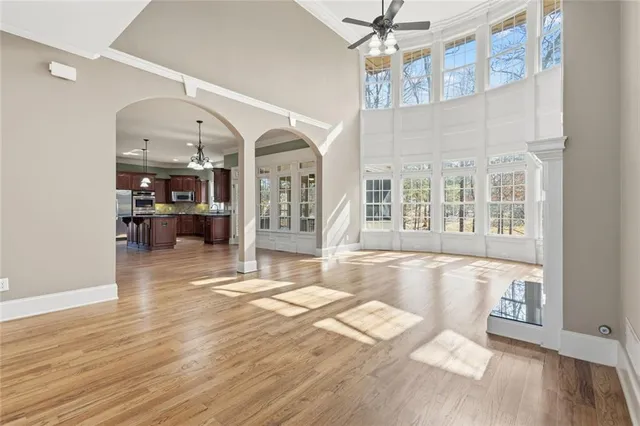 an empty room with windows and fireplace
