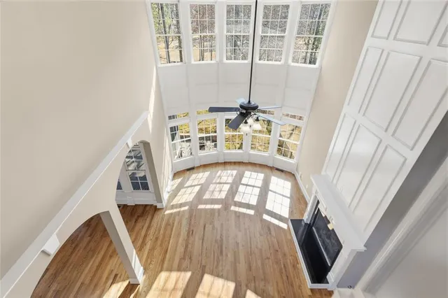 a view of a hallway with wooden floor and stairs