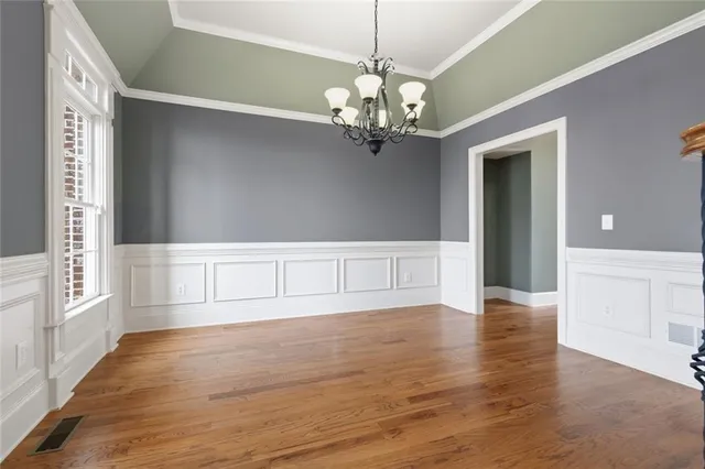 a view of a livingroom with wooden floor and a fireplace