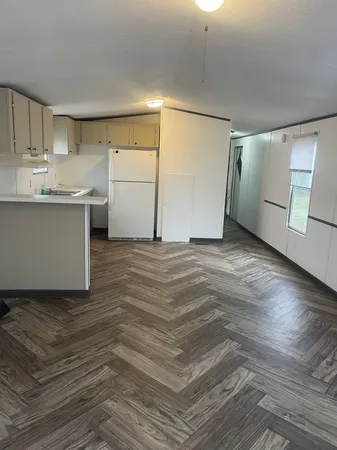 a view of a kitchen with a sink and cabinets