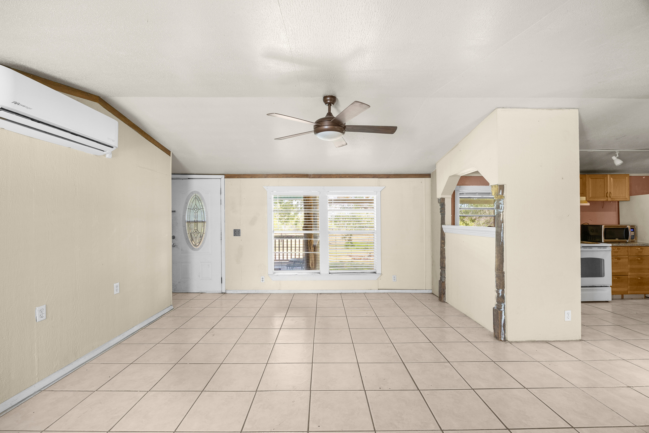 147 Community Center Road Rosanky, TX 78953 - Photo 7 of 33 Unfurnished room with a ceiling fan, light tile patterned floors, and vaulted ceiling
