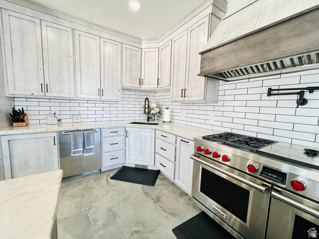 100 Whit Lane Georgetown, ID 83239 - Photo 8 of 76 Kitchen with stainless steel appliances, light stone countertops, concrete flooring, recessed lighting, and backsplash