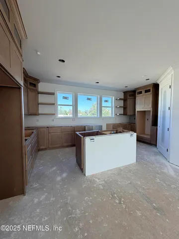 a room with furniture a air conditioner vent and a window