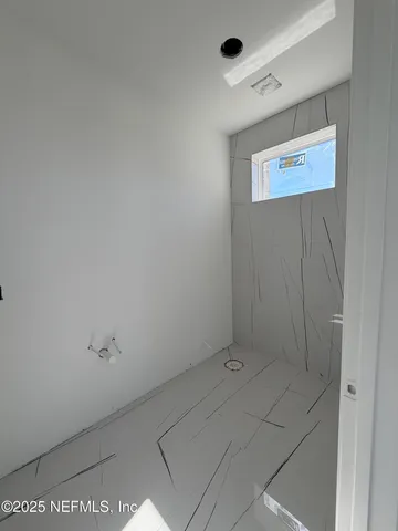 a view of an empty room with two window