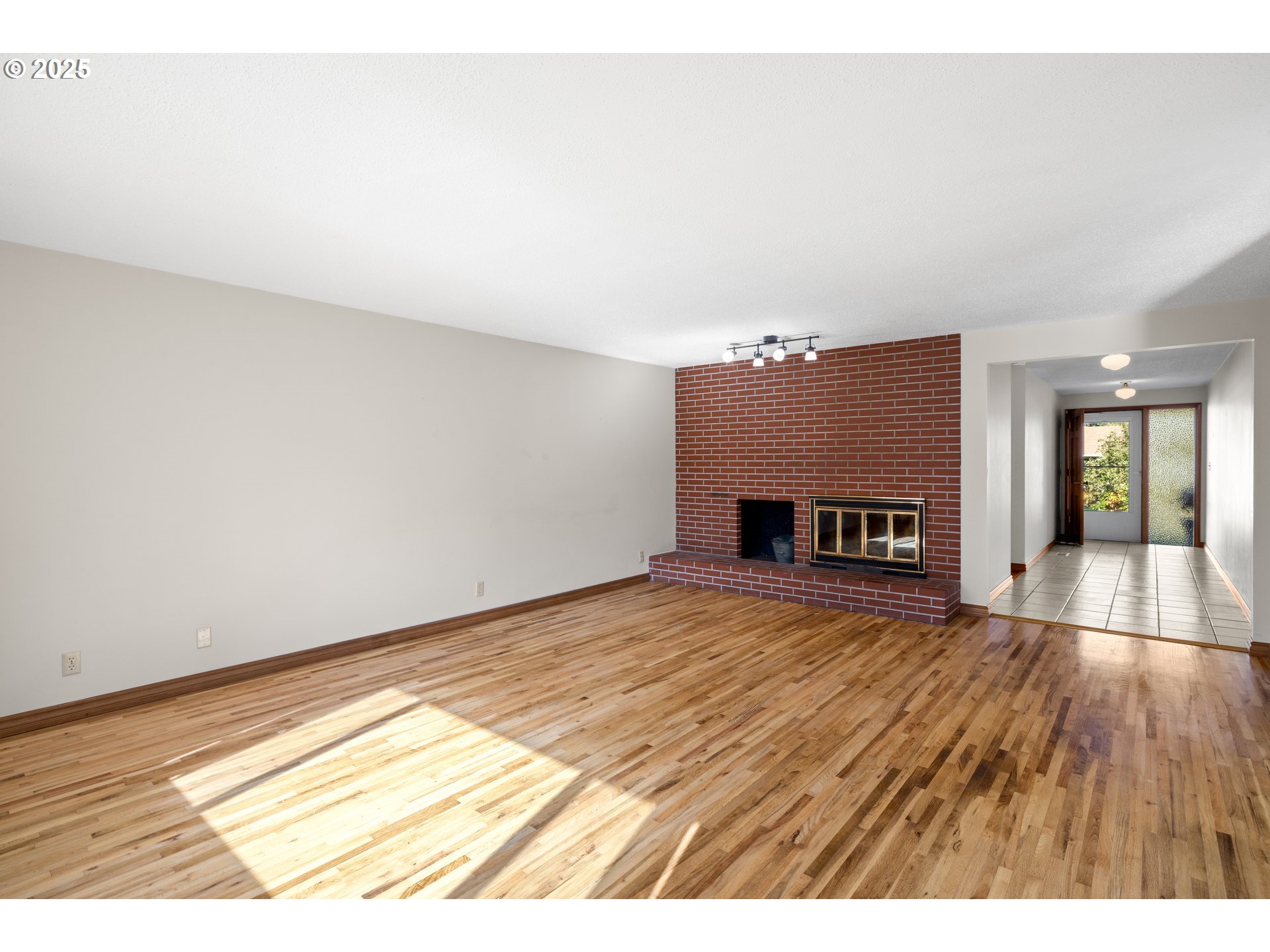 3396 Southeast Loeffelman Road Milwaukie, OR 97222 - Photo 7 of 41 a view of empty room with wooden floor and fireplace