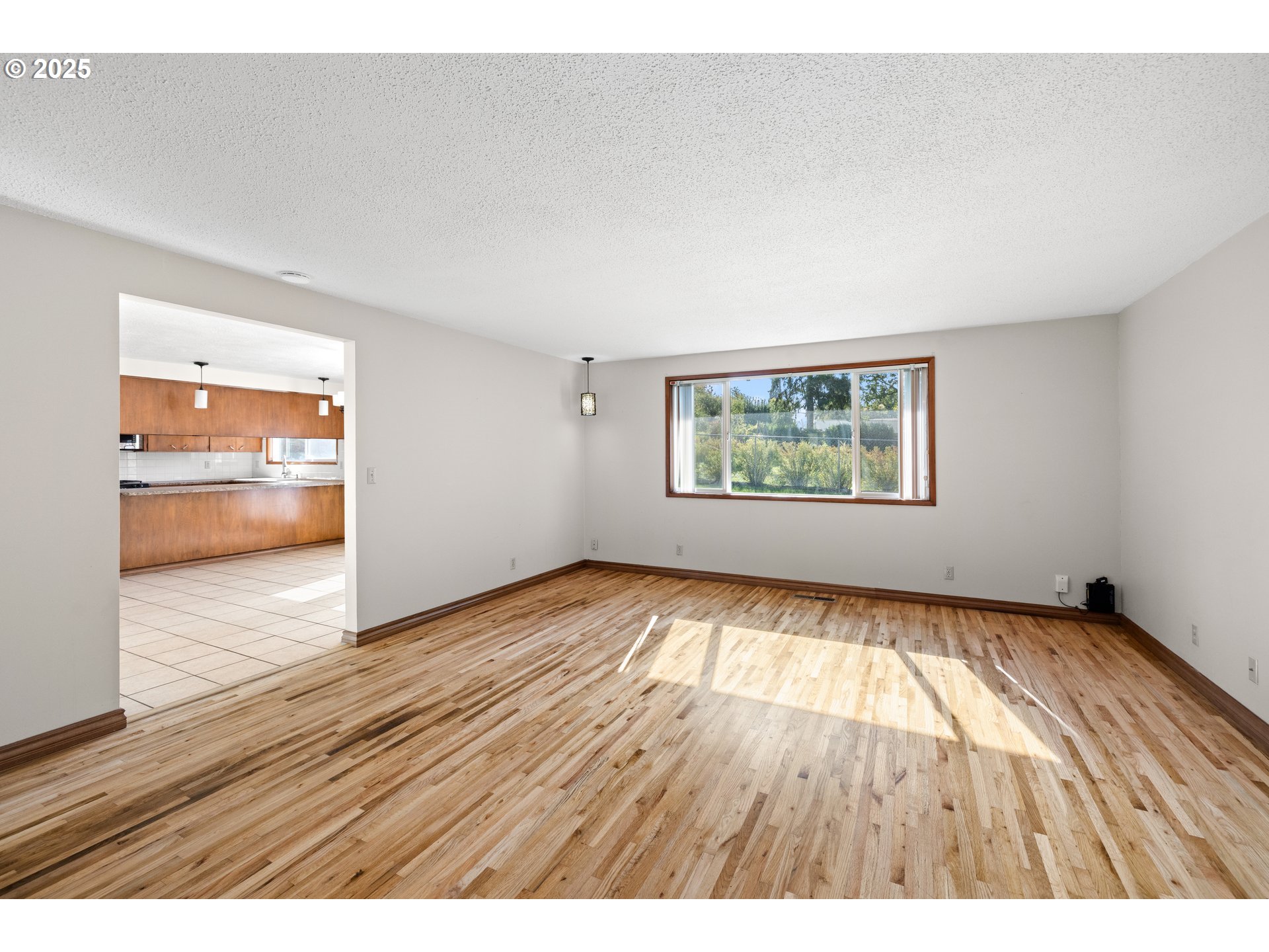 3396 Southeast Loeffelman Road Milwaukie, OR 97222 - Photo 9 of 41 wooden floor in an empty room with a window