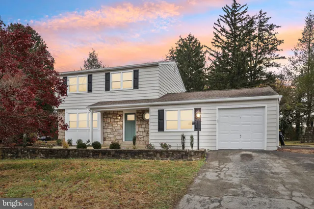 a front view of a house with a garden and yard