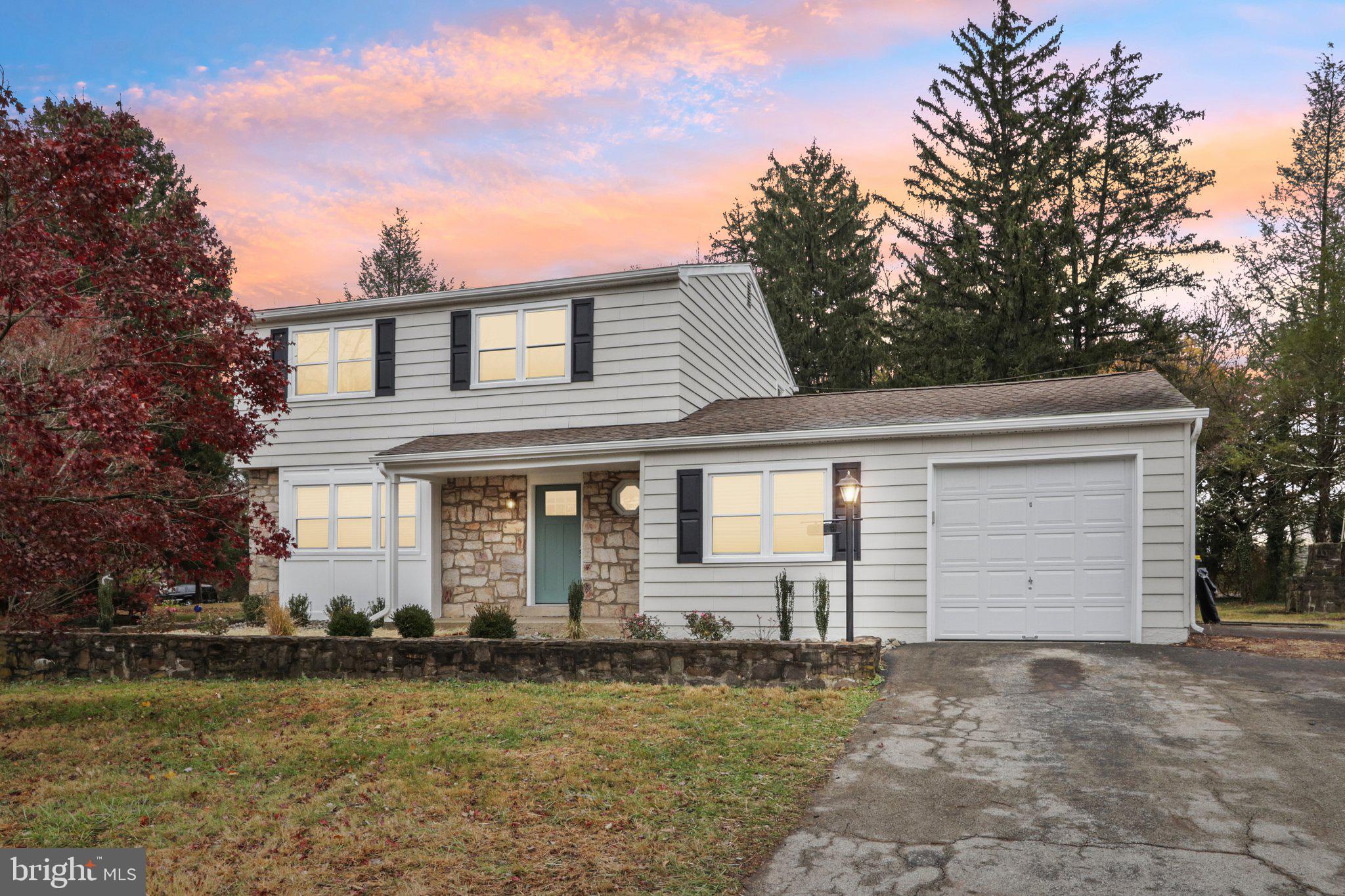 a front view of a house with a garden and yard