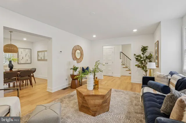 a dining room with furniture and wooden floor