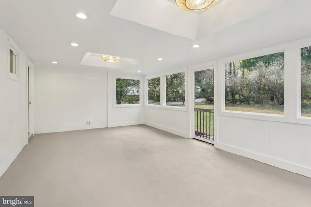 a bedroom with a bed and a lamp on dresser