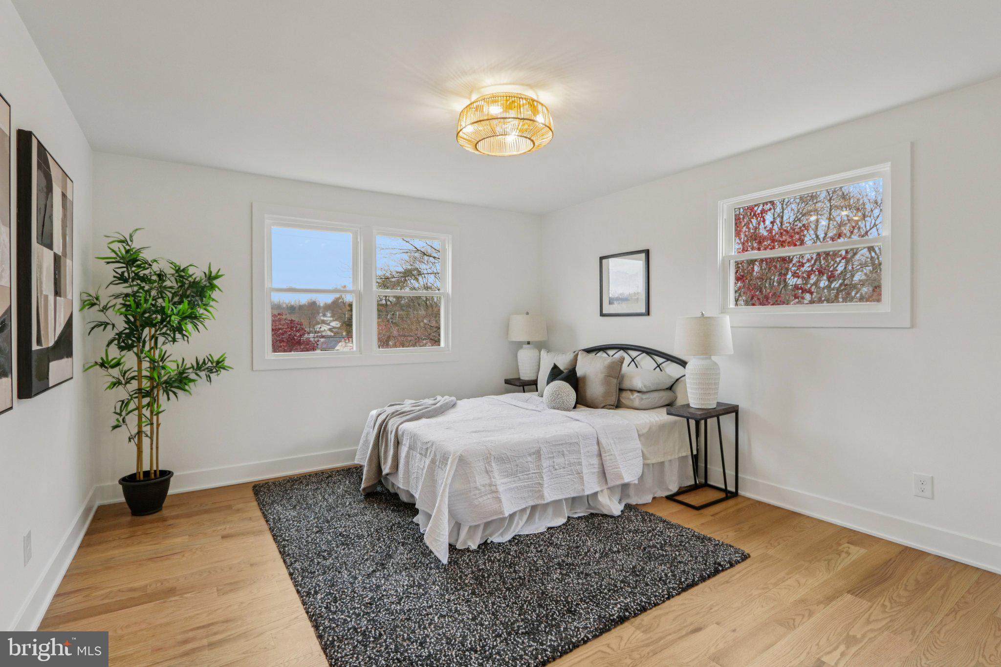3004 North Wales Road Norristown, PA 19403 - Photo 29 of 44 a bedroom with a large bed and a potted plant