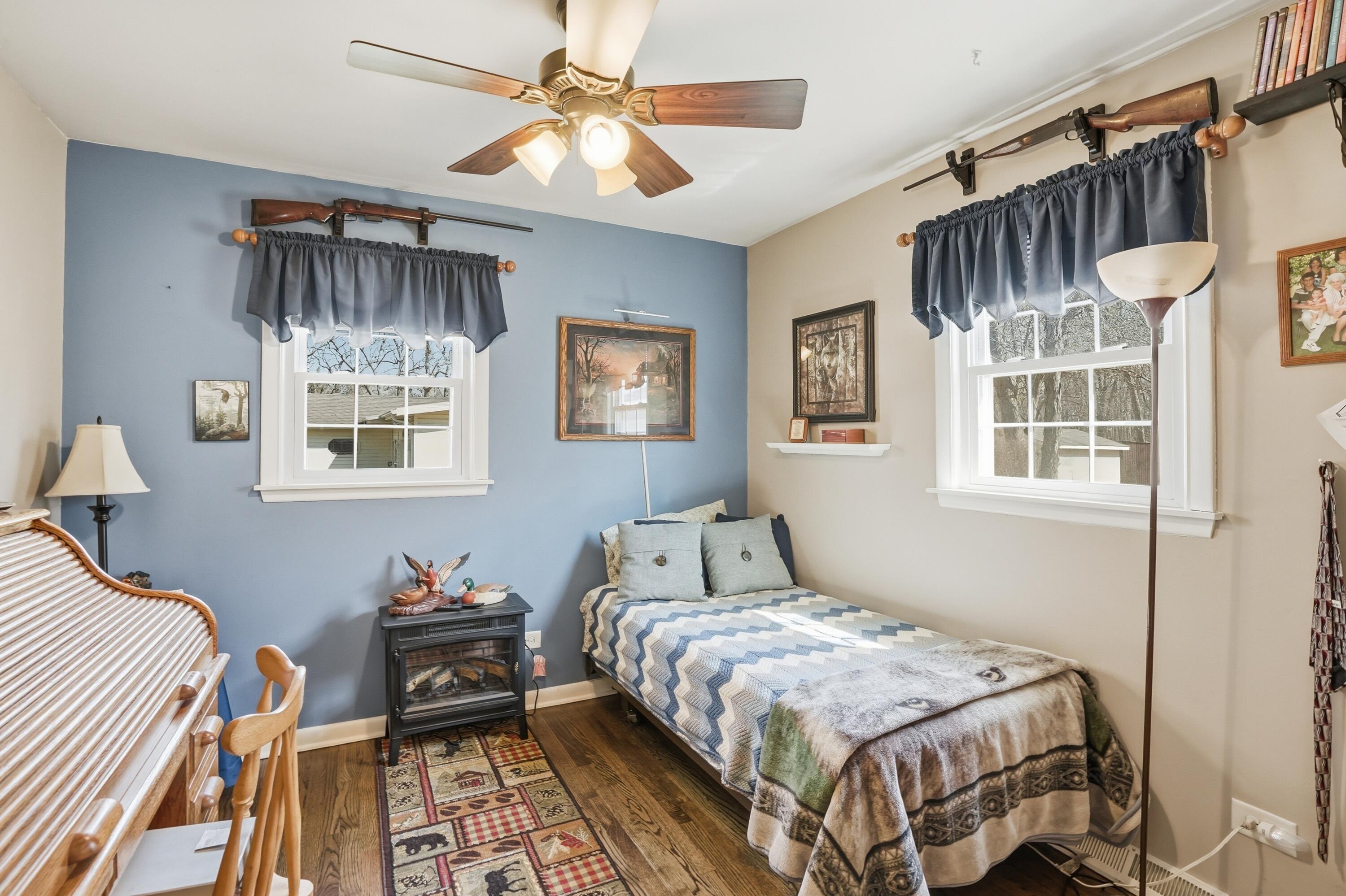 8951 State Line Road Dyer, IN 46311 - Photo 11 of 28 a bedroom with a bed and a chandelier