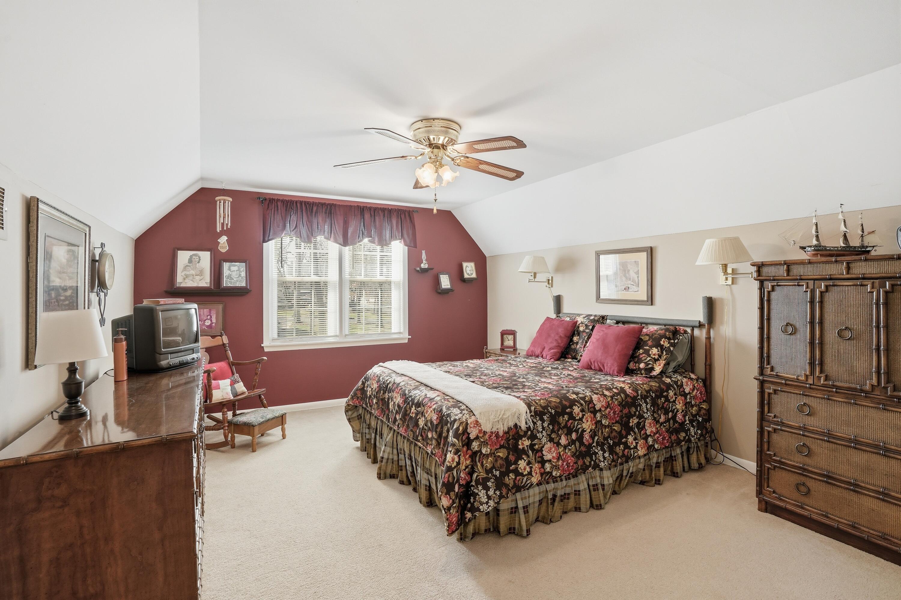 8951 State Line Road Dyer, IN 46311 - Photo 14 of 28 a bedroom with a bed dresser and a flat tv screen