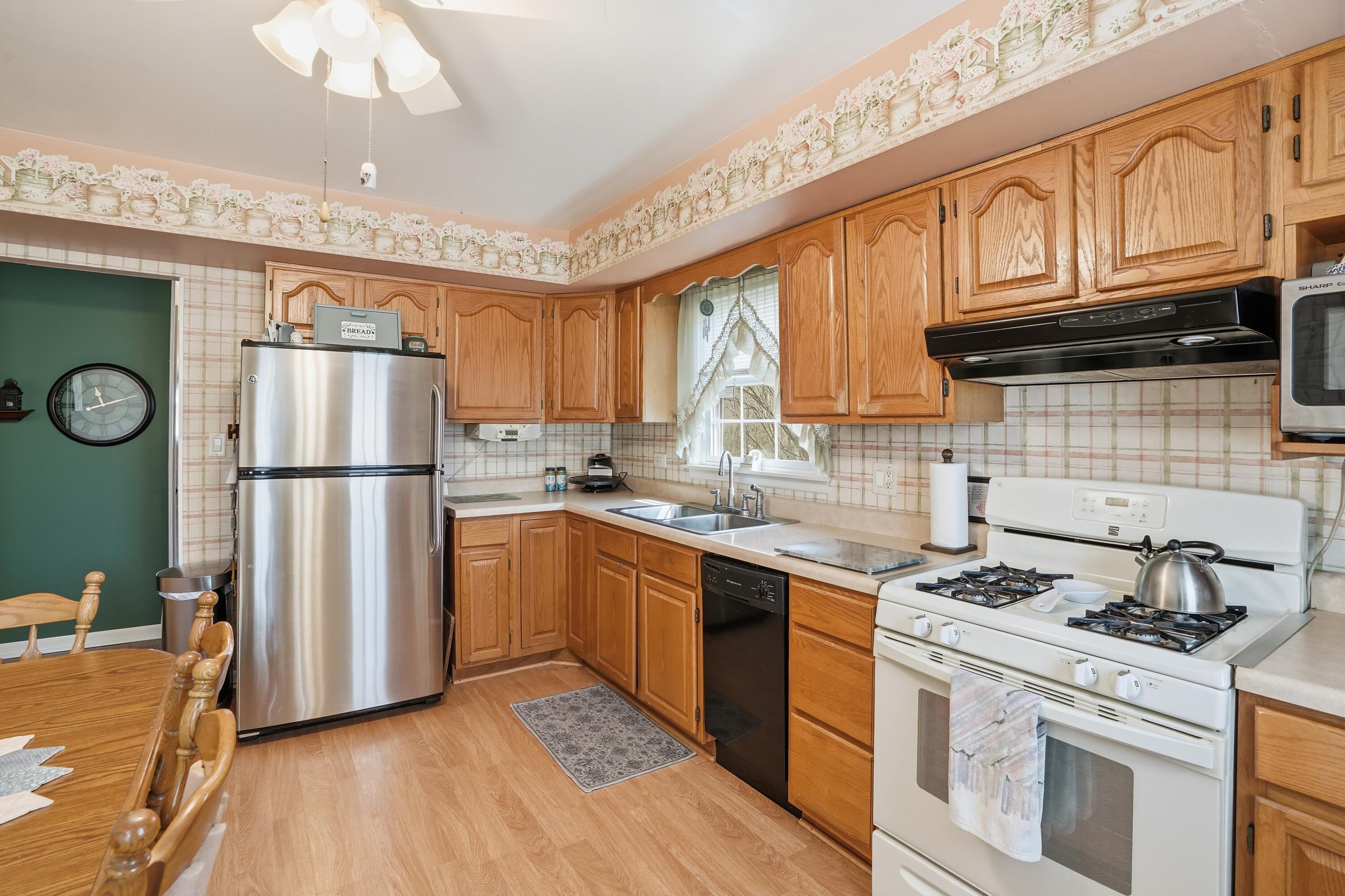 8951 State Line Road Dyer, IN 46311 - Photo 8 of 28 a kitchen with granite countertop a refrigerator stove top oven and sink