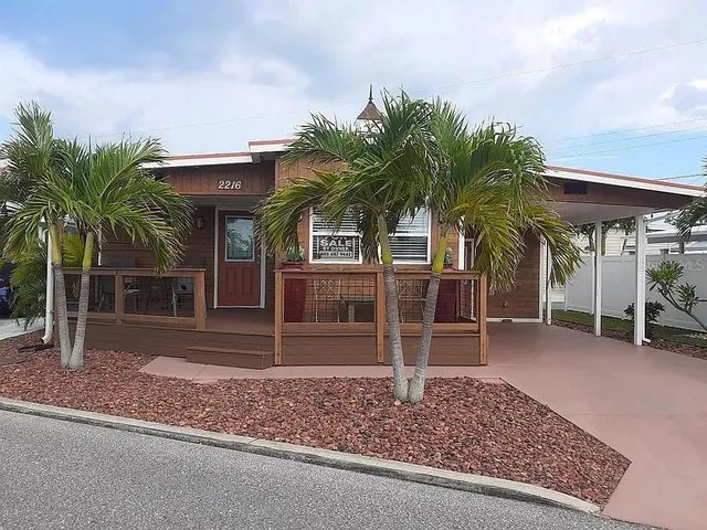 front view of a house with a patio and a yard