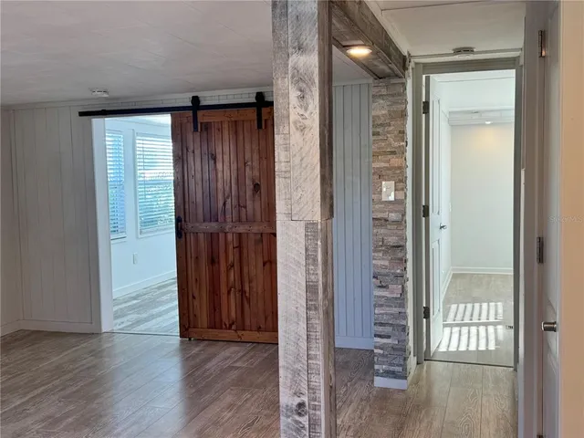 a view of a hallway with wooden floor