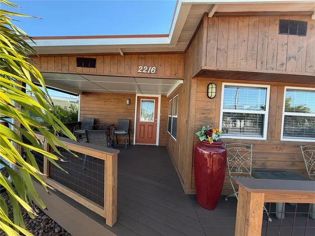 a view of dinning table and chairs in the balcony