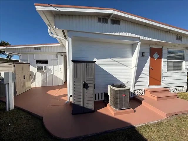 a couple of cars parked in front of a building
