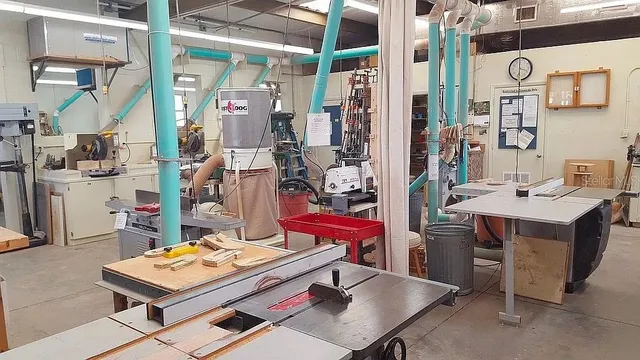 a kitchen with stainless steel appliances granite countertop a table chairs sink and wooden floor