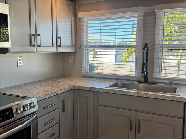 a kitchen with granite countertop a sink and a window