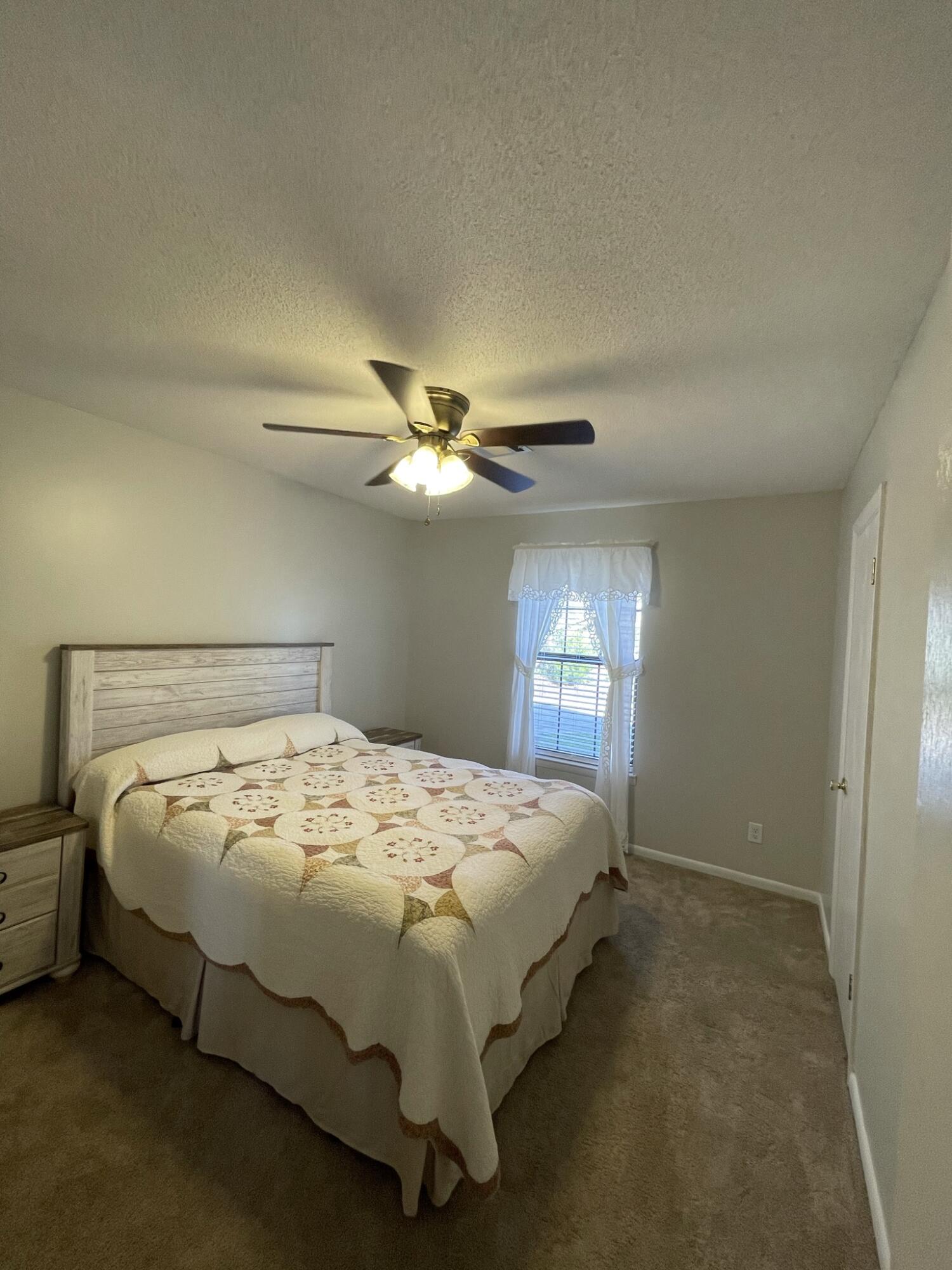 455 Ridge Lake Road Crestview, FL 32536 - Photo 17 of 22 a bedroom with a bed and a ceiling fan