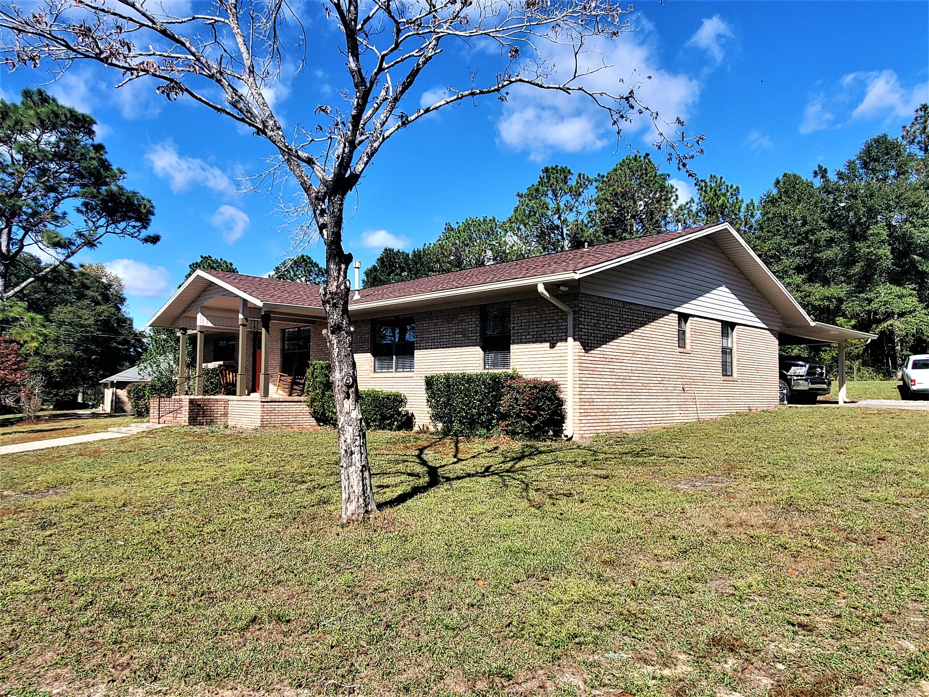 455 Ridge Lake Road Crestview, FL 32536 - Photo 5 of 22 a house with trees in the background