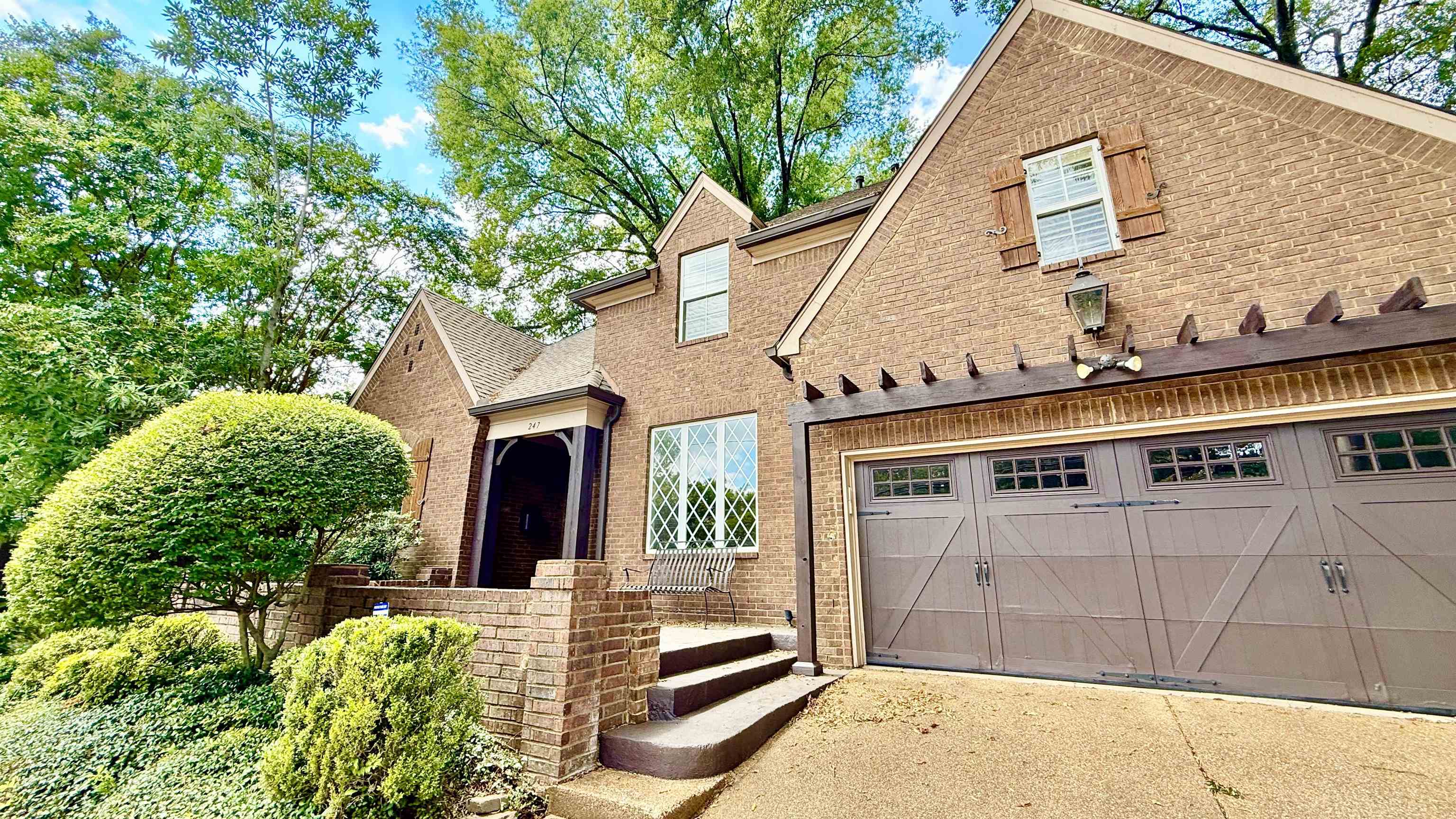 247 South Greer Street Memphis, TN 38111 - Photo 2 of 29 View of front of property featuring driveway, brick siding, a shingled roof, and a garage
