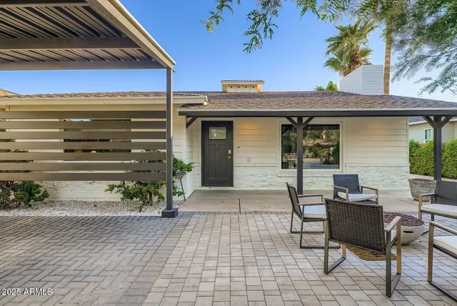 a front view of a house with outdoor seating