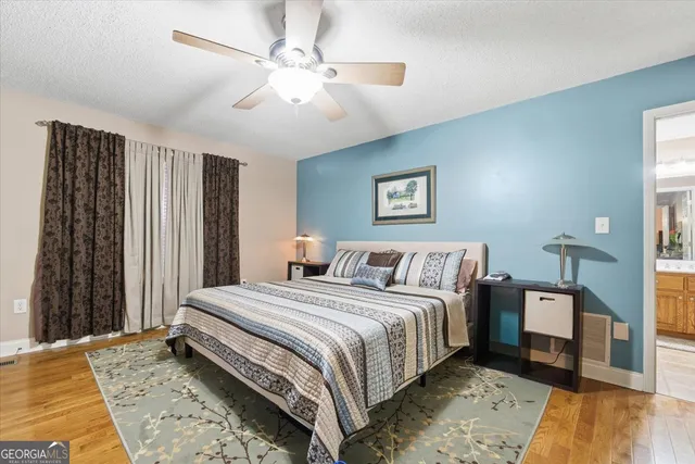 a bedroom with a large bed and a chandelier