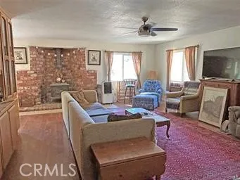 a living room with furniture a flat screen tv and a large window