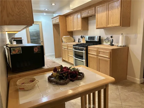 a kitchen with stainless steel appliances a stove a microwave a sink and cabinets