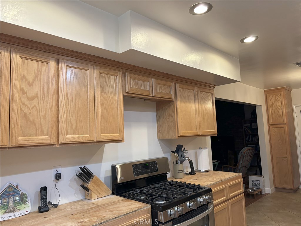 42930 Lake Hughes Road Lake Hughes, CA 93532 - Photo 29 of 54 a kitchen with stainless steel appliances granite countertop a stove a sink and a microwave