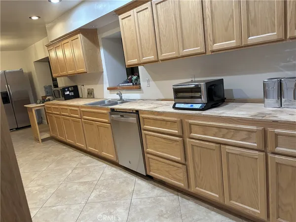 a kitchen with cabinets a sink and appliances