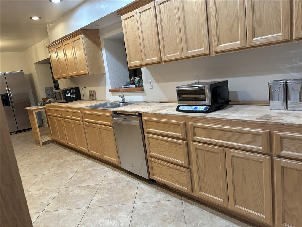 42930 Lake Hughes Road Lake Hughes, CA 93532 - Photo 30 of 54 a kitchen with cabinets a sink and appliances