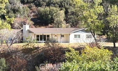 42930 Lake Hughes Road Lake Hughes, CA 93532 - Photo 3 of 54 a front view of a house with a garden