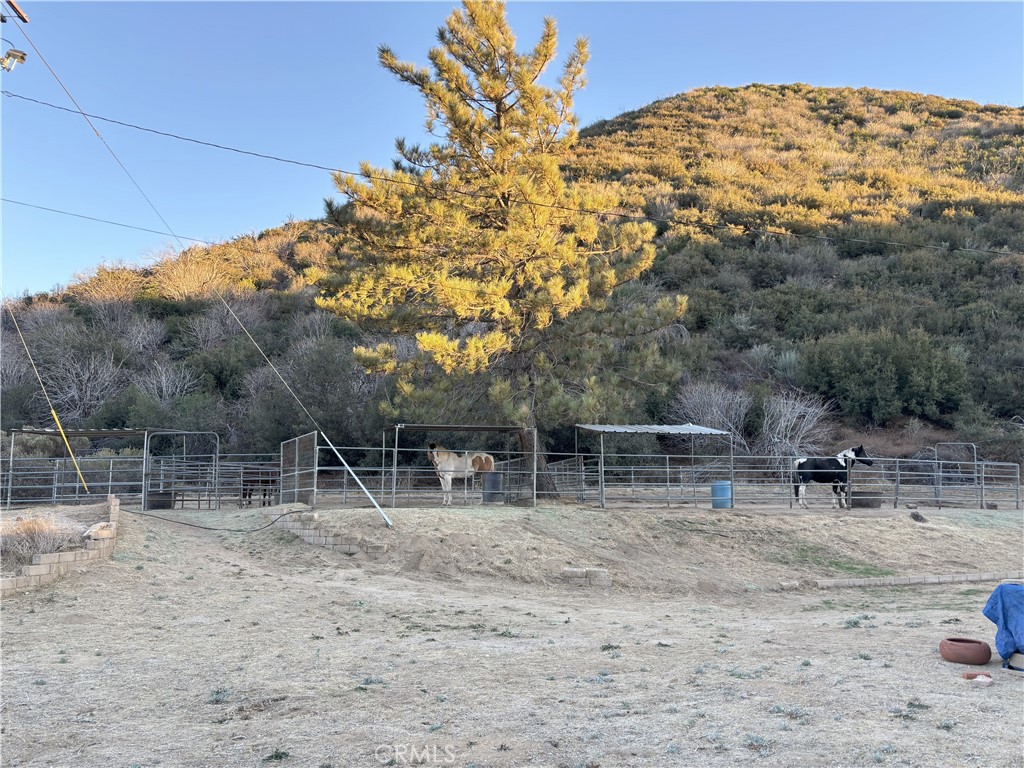 42930 Lake Hughes Road Lake Hughes, CA 93532 - Photo 31 of 54 a backyard of a house with table and chairs