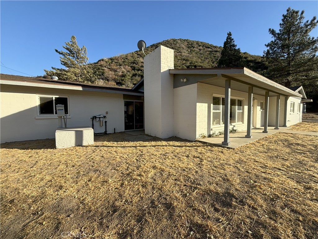 42930 Lake Hughes Road Lake Hughes, CA 93532 - Photo 6 of 54 a front view of a house with a yard