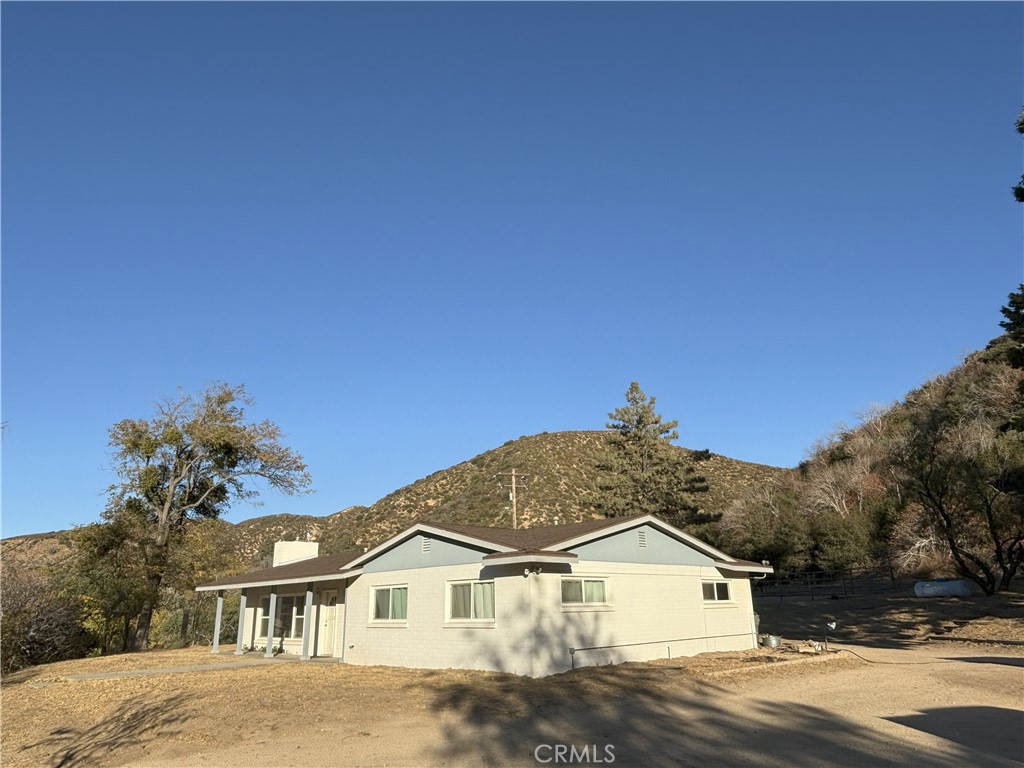 42930 Lake Hughes Road Lake Hughes, CA 93532 - Photo 7 of 54 a front view of a house with a yard