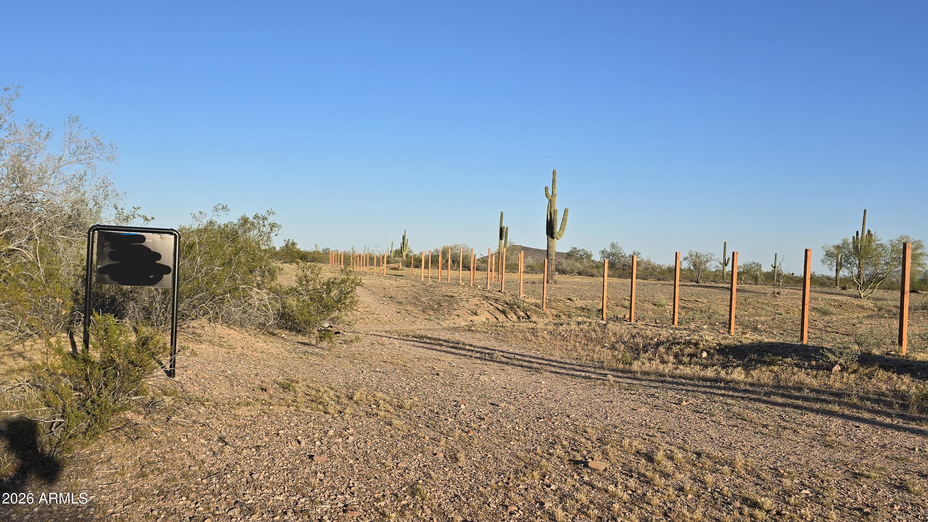 31275 West Cloud Road Wittmann, AZ 85361 - Photo 2 of 31 a view of a dry yard with wooden fence