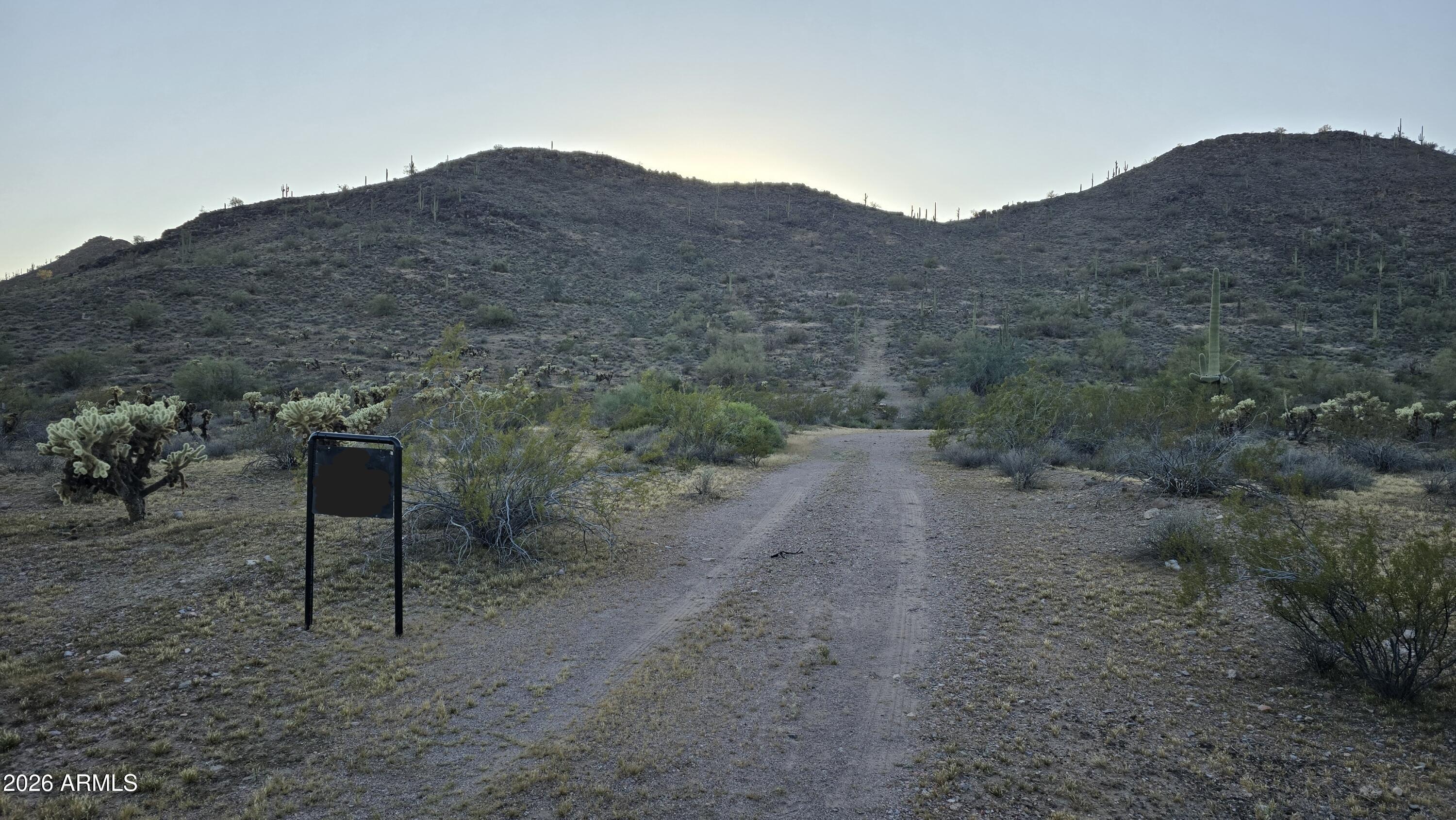 31275 West Cloud Road Wittmann, AZ 85361 - Photo 31 of 31 a view of a dry field with mountains in the background