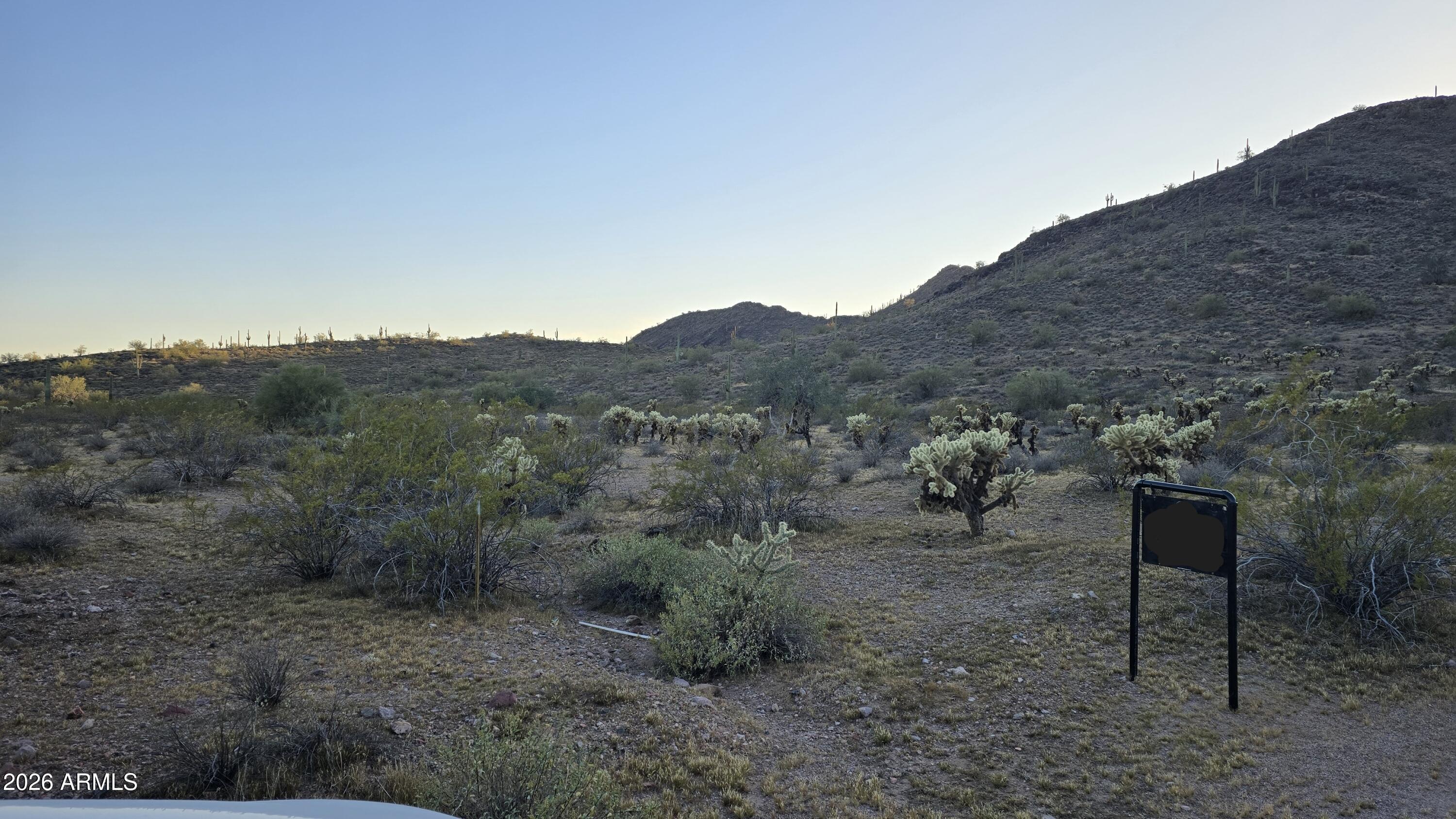 31275 West Cloud Road Wittmann, AZ 85361 - Photo 5 of 31 a view of a dry field with mountains in the background