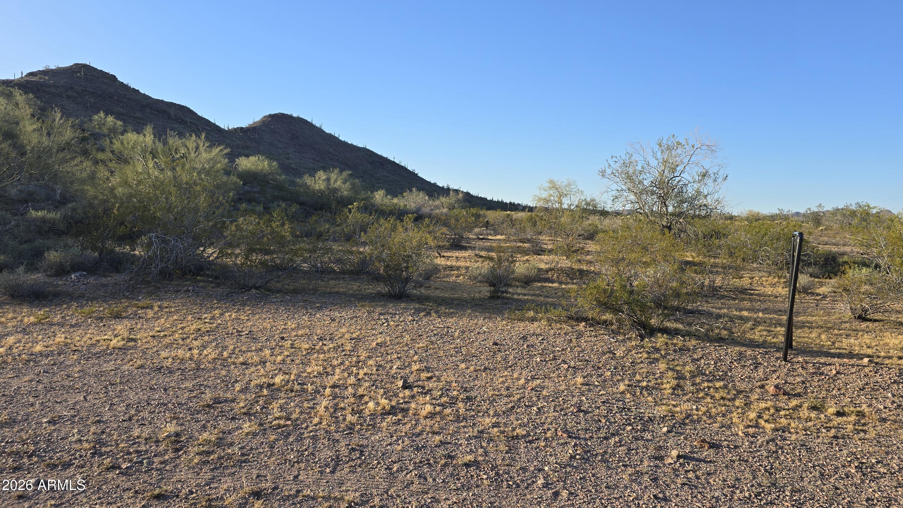 31275 West Cloud Road Wittmann, AZ 85361 - Photo 9 of 31 a view of a yard with a wooden fence