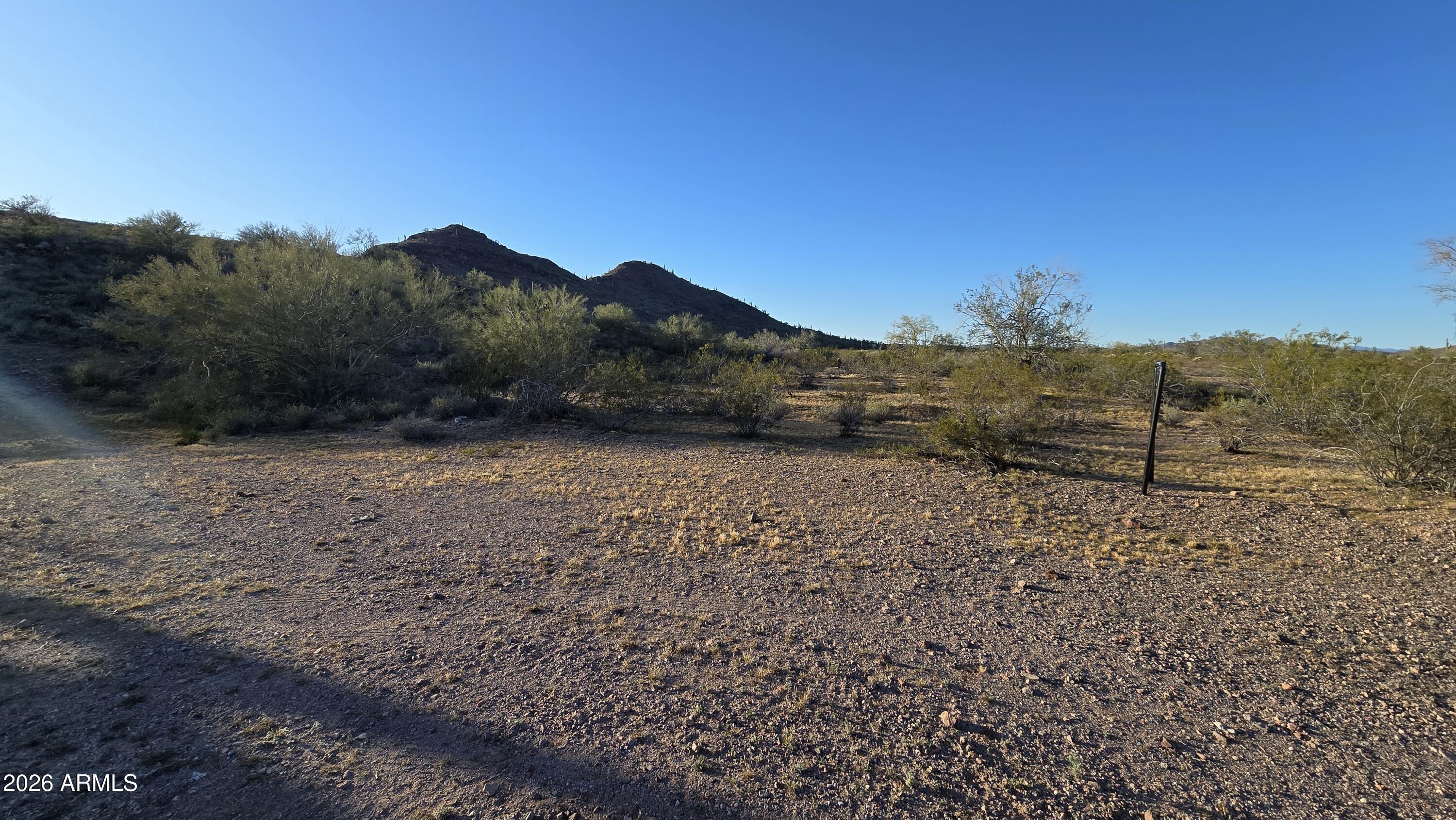 31275 West Cloud Road Wittmann, AZ 85361 - Photo 10 of 31 a view of a dry yard with wooden fence