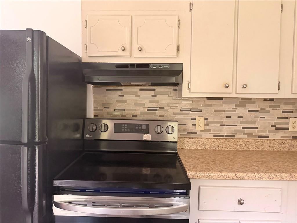 3151 Bluebird Lane Decatur, GA 30032 - Photo 7 of 16 a stove top oven sitting inside of a kitchen