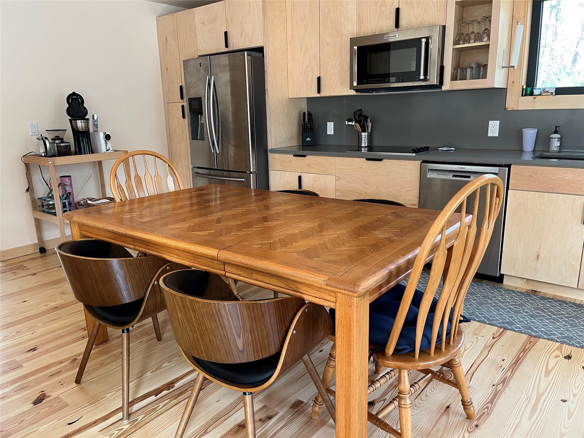 1252 Cardinal Road Brevard, NC 28712 - Photo 4 of 31 a kitchen with stainless steel appliances granite countertop a dining table chairs and granite counter tops