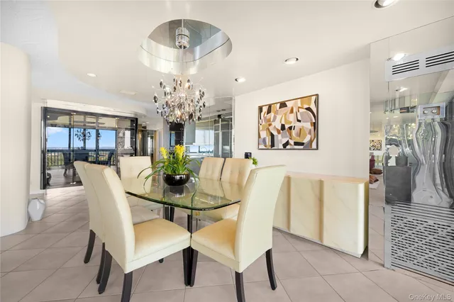 a view of a dining room with furniture and chandelier