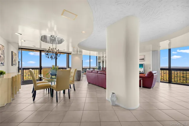 a dining room with furniture and a chandelier